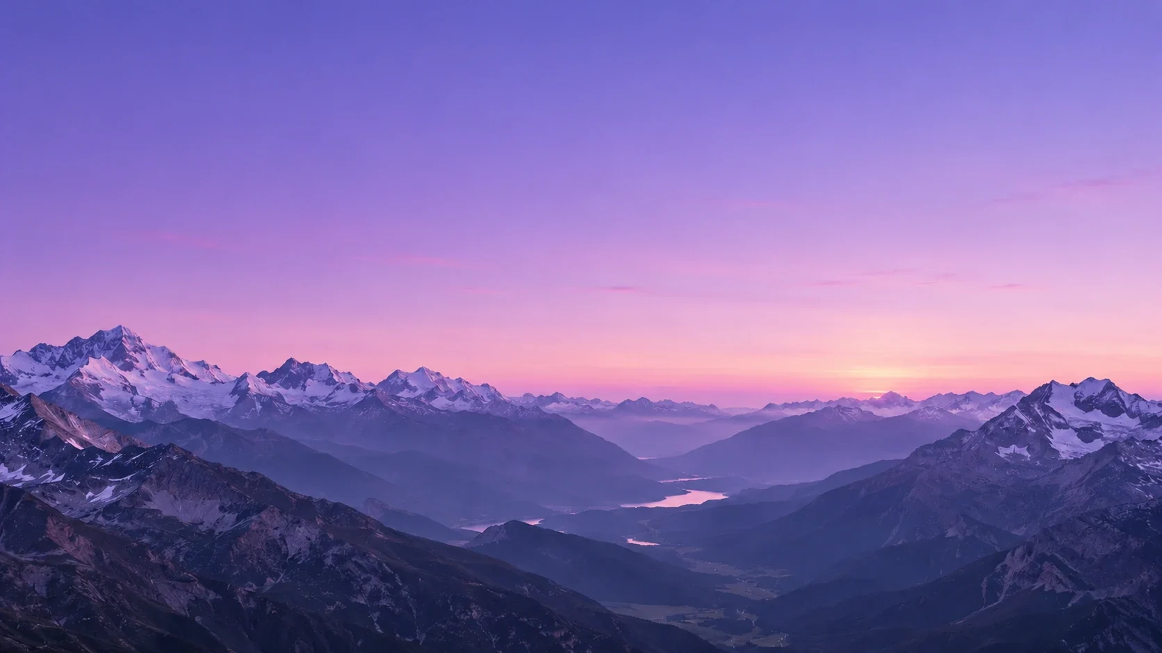 Layered mountains beneath a lavender dawn sky